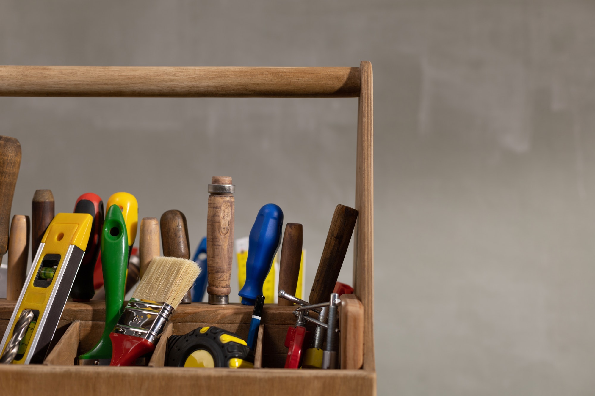 Construction tools and toolbox on wooden table background texture. Tools kit with tool box